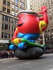 If the Kool-Aid Man Balloonicle were an actual pitcher of Kool-Aid there would be over 10,000 gallons to share. High as 3 story building, as wide as 5 taxi cabs, 8 handlers.